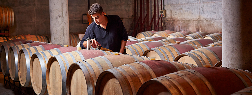 a person standing in front of a barrel