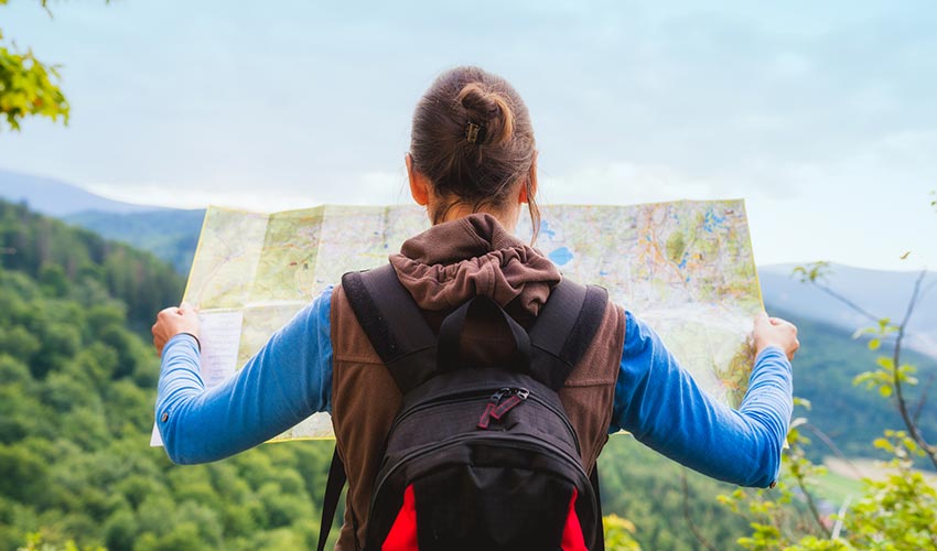 hiker reads map