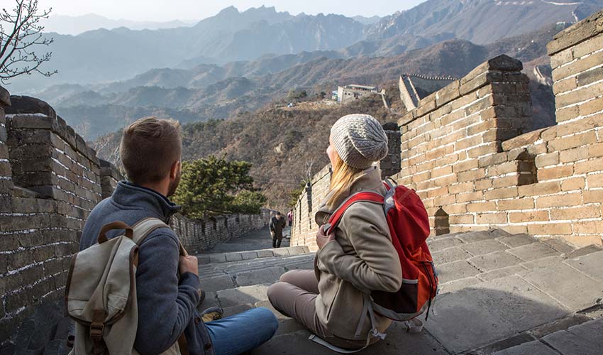 young couple hiking the great wall