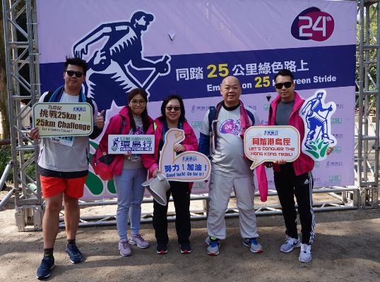 a group of people holding a sign posing for the camera