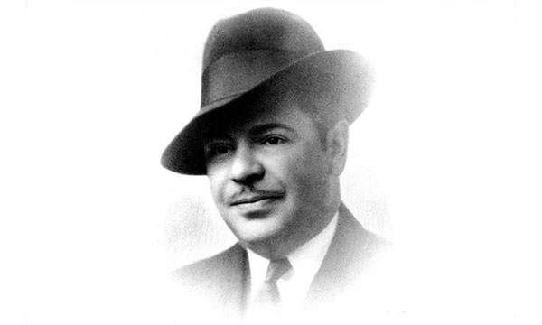 a young man wearing a hat posing for the camera