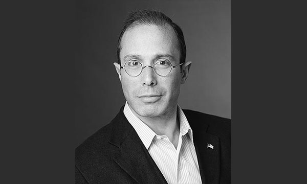 Evan G. Greenberg wearing a suit and tie looking at the camera