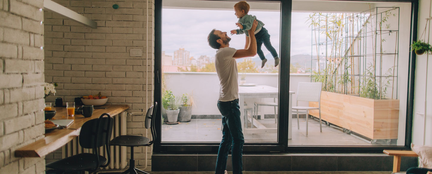 man throwing up child