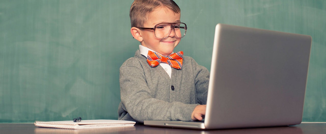 kid playing with laptop