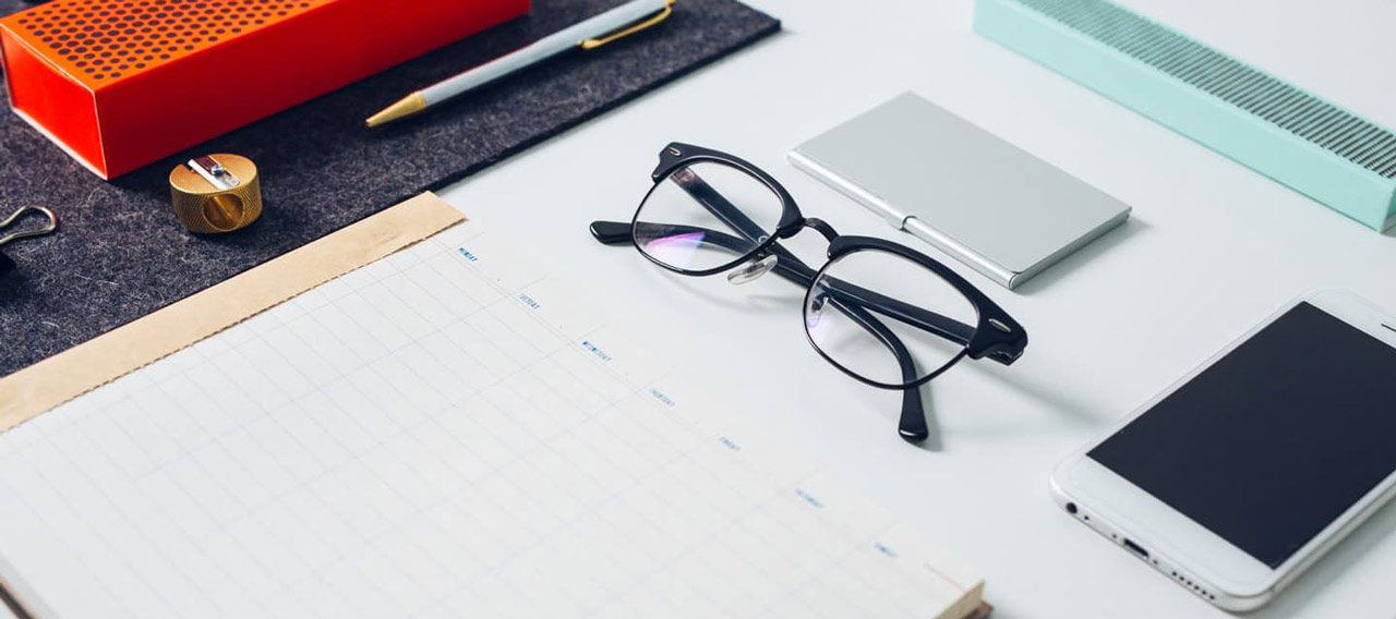phone notebook and glasses