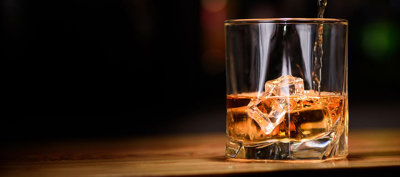 pouring whiskey to the glass