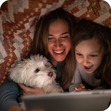 father and daughters playing in yard